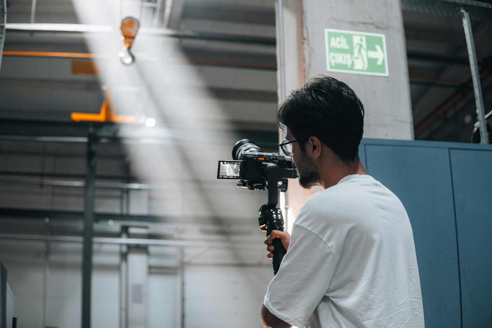 A man standing in a room with a camera