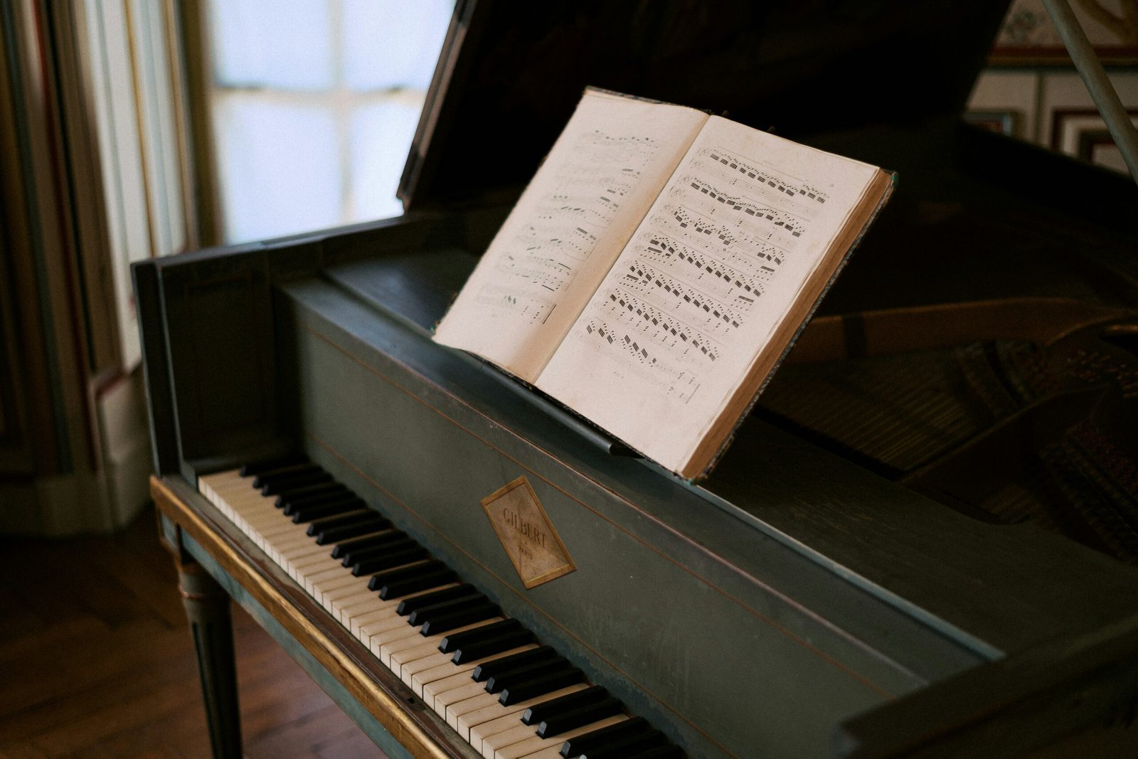 An open book sitting on top of a piano